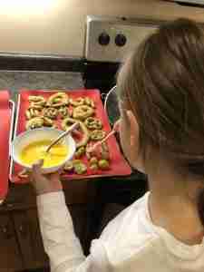 painting egg wash onto soft pretzels
